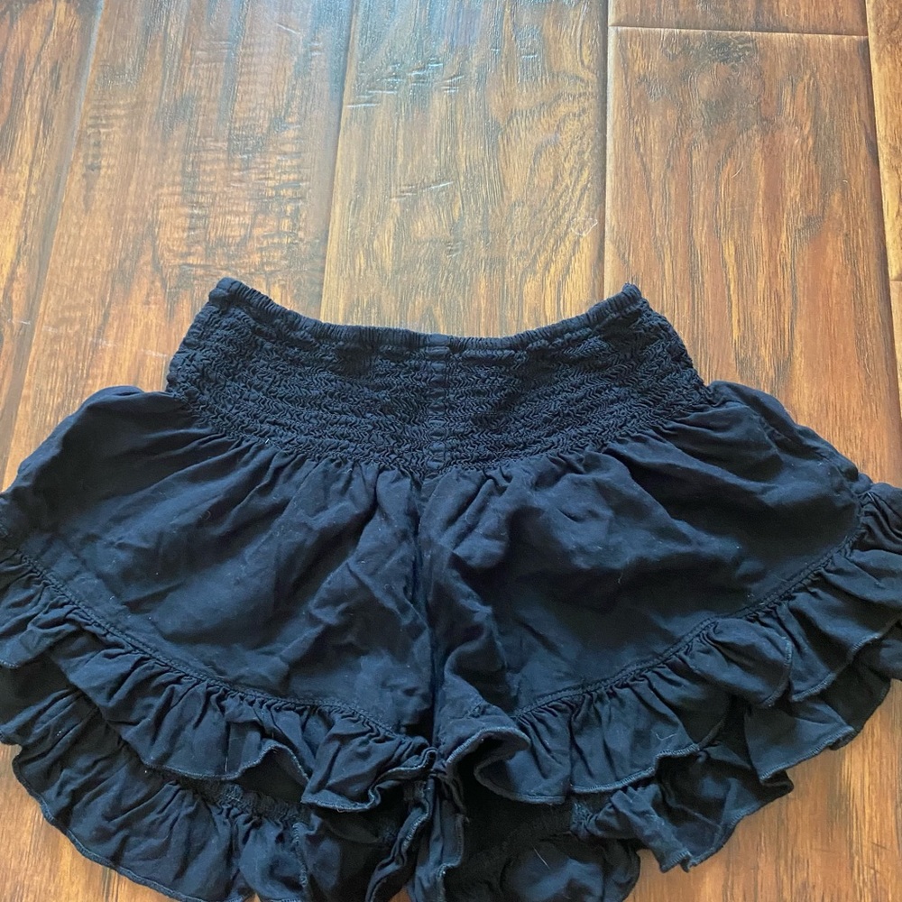 Black ruffled shorts.